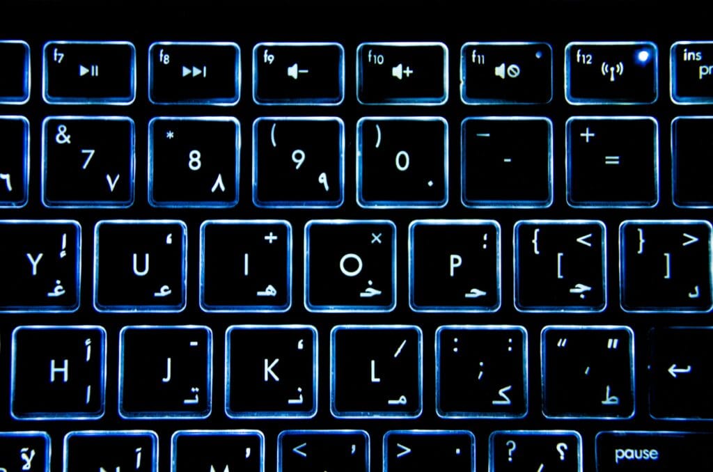 Detailed view of a backlit keyboard with Arabic numerals and symbols.